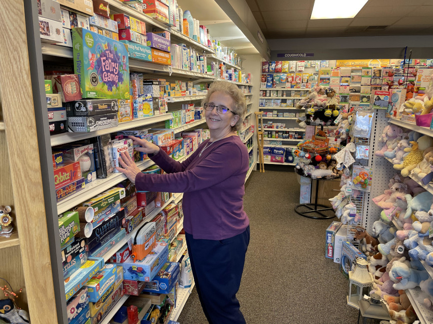 Linda Balliet stocking shelves in Balliet's Family Pharmacy